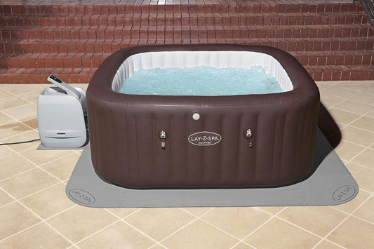 Floor protector mat laid out for square hot tub