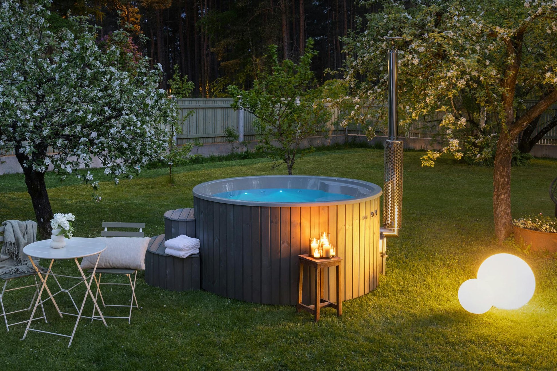 Polar Spa wood-fired hot tub at night with RGB lighting