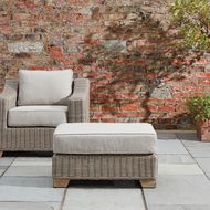 Capri Collection outdoor foot stool in garden setting