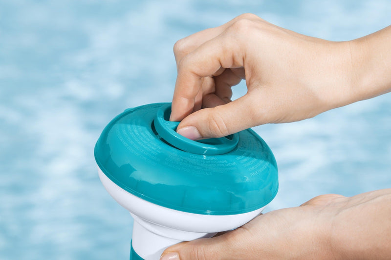 Chlorine floater dispensing tablets in pool