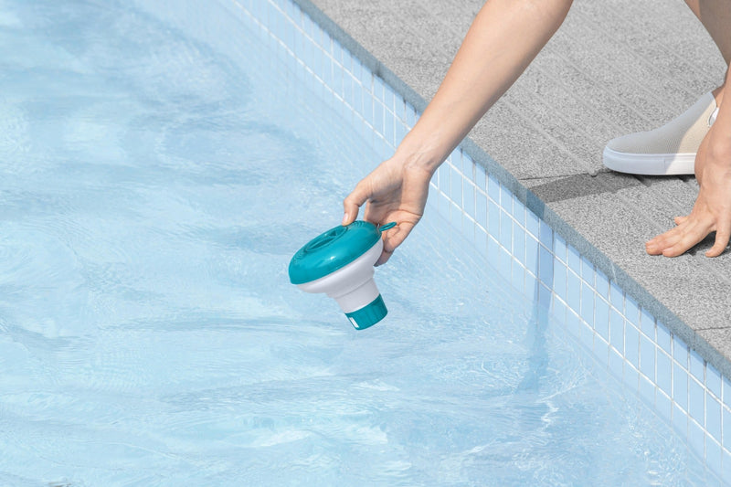Chemical floater dispenser in use poolside