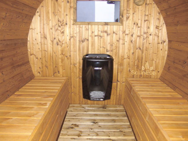 Electric barrel sauna interior with electric heater