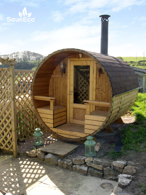 Compact barrel sauna side view showing thermowood construction