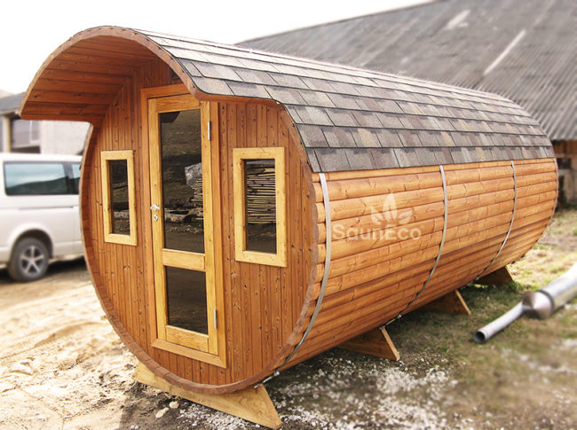 Three room barrel sauna side view showing thermowood construction