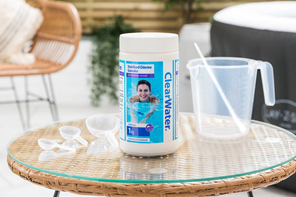 Hot tub owner adding ClearWater chlorine granules to spa water