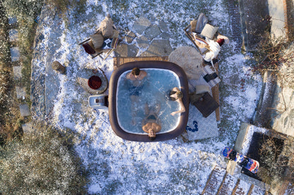 lay-Z-Spa Maldives large square inflatable hot tub in snowy garden