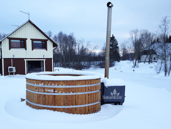 Large larch wood hot tub installed outdoors