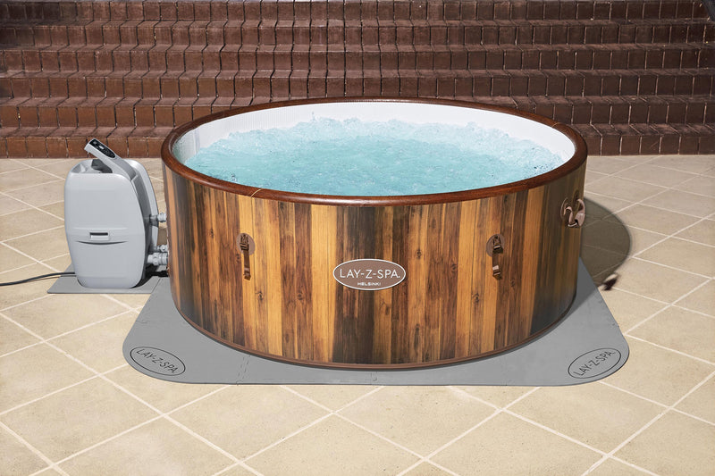 Floor protector mat fitted under round hot tub