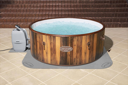 Floor protector mat fitted under round hot tub