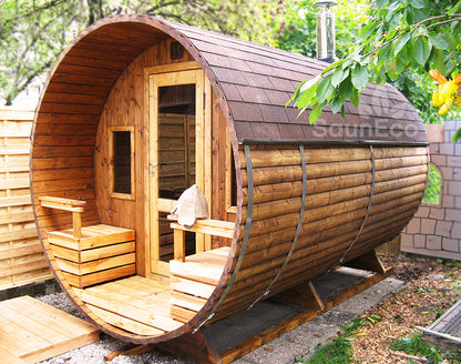 Two-room barrel sauna lodge interior showing wood-fired heater setup