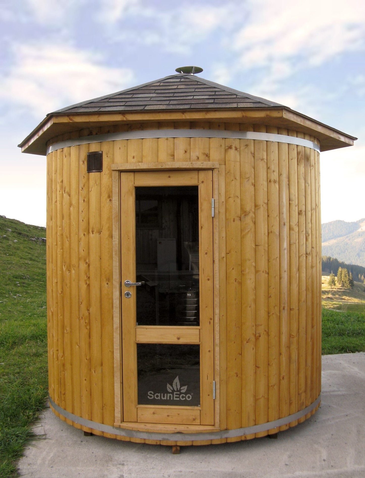 Upright garden sauna lodge installed in a compact garden space