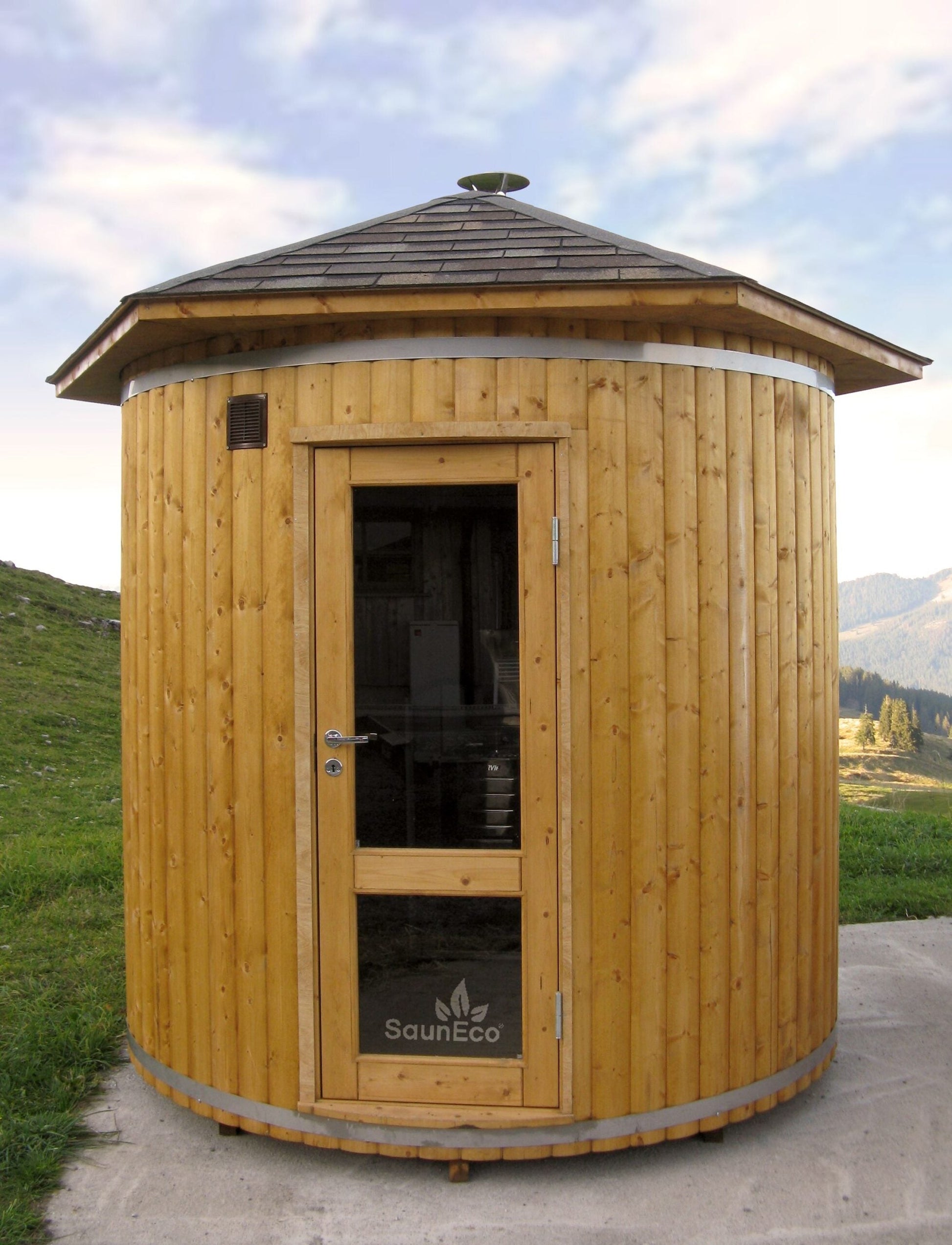 Upright garden sauna lodge installed in a compact garden space